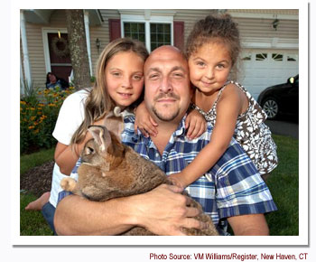 Kayden, her father, Josh, and her sister, Madison Lydsky, pose with Sandy the bunny.